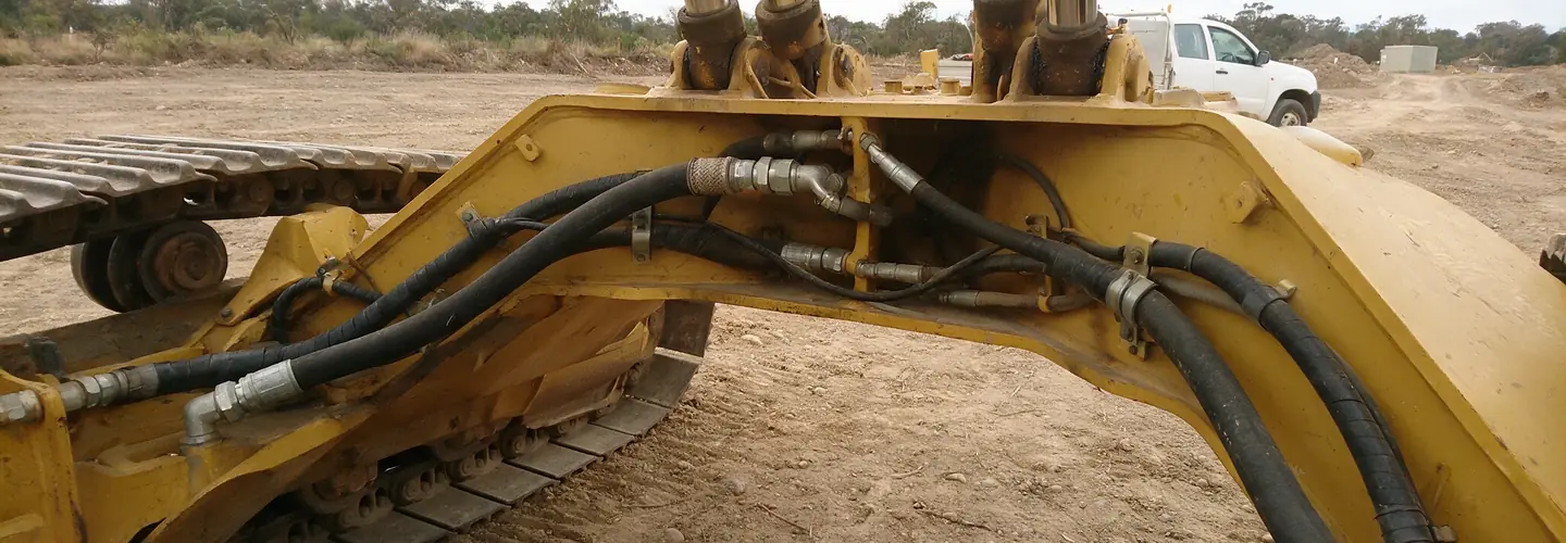 Flatbed truck loaded with a roller at dusk after hydraulic and mechanical repairs in Queanbeyan