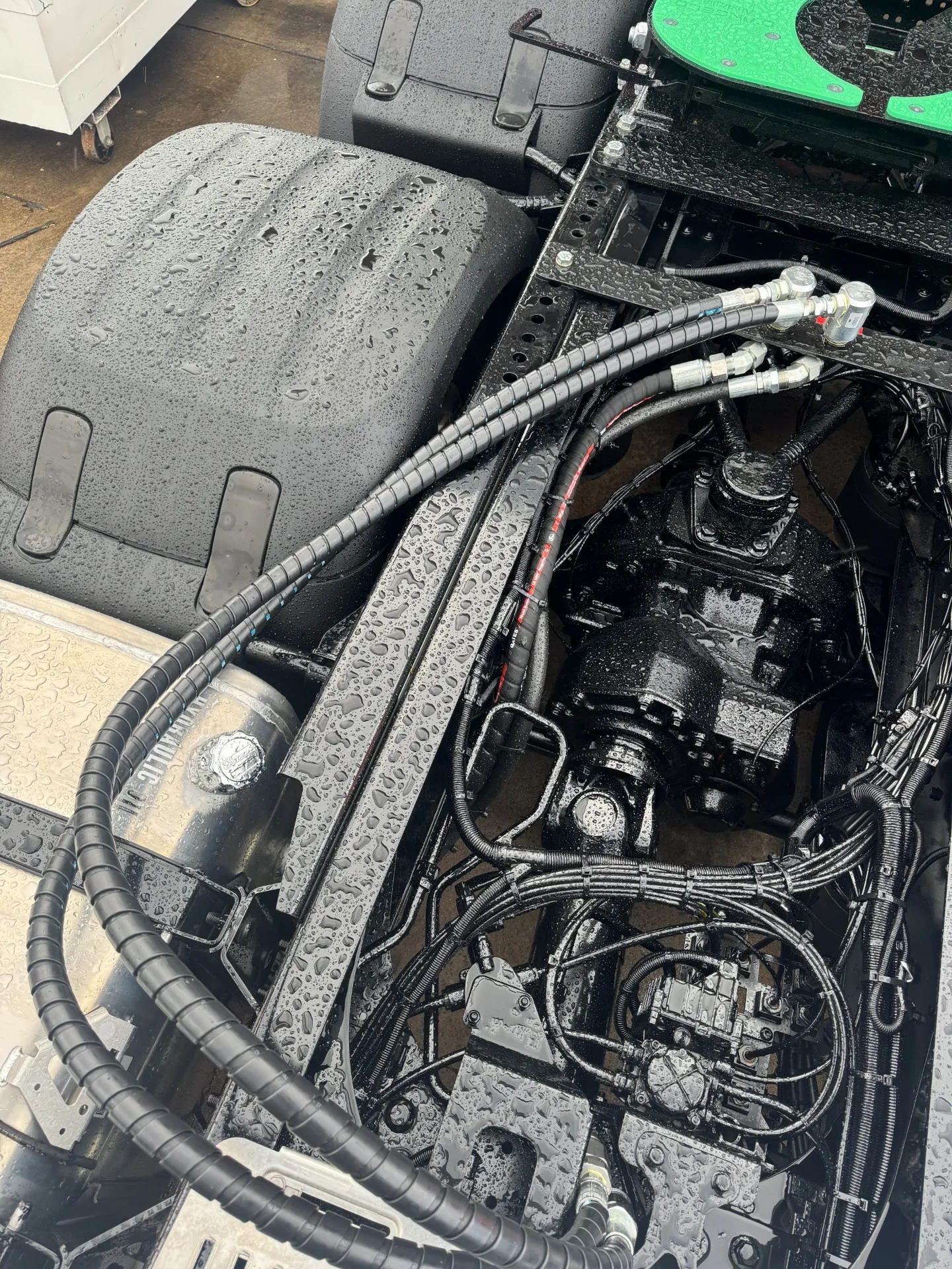 Hydraulic hoses and fittings routed through an engine bay during hydraulic repairs in Queanbeyan