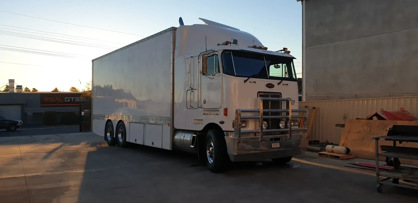 Peterbilt cabover service truck parked outside the JW Hydraulics & Mechanical workshop for heavy vehicle repairs