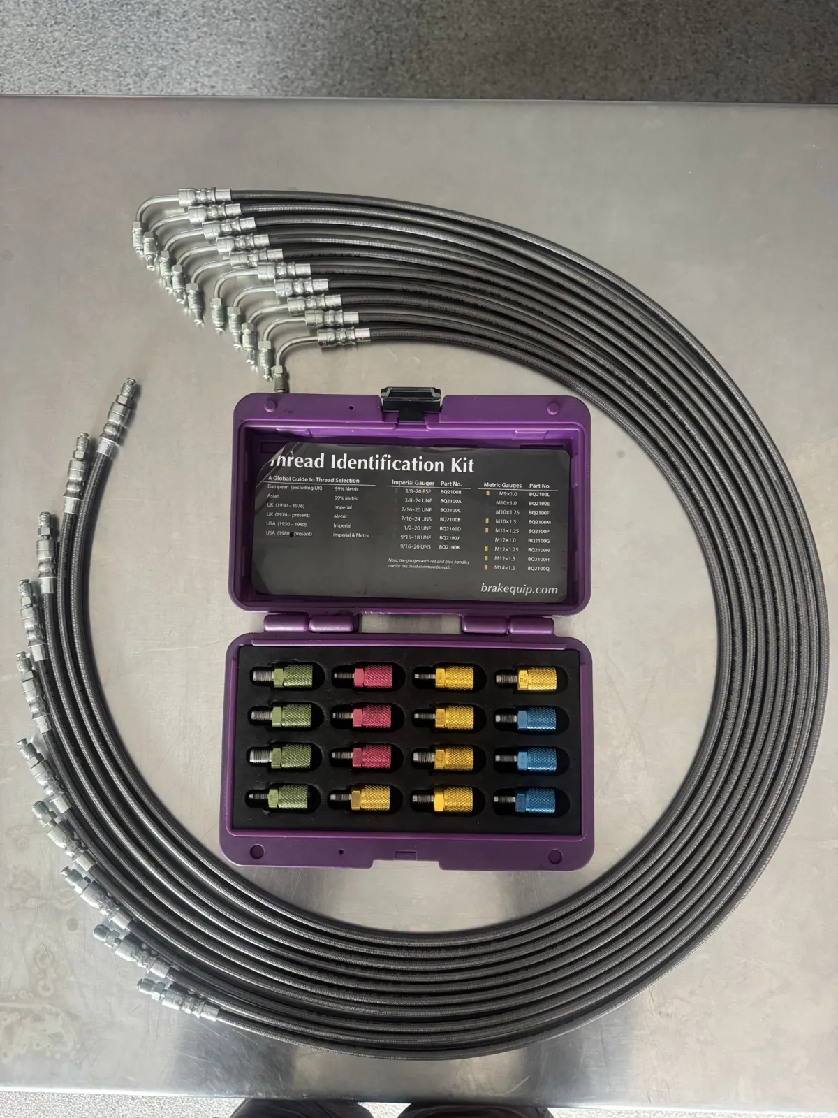Coiled hydraulic hose set with a thread identification kit used to match hose fittings in Canberra